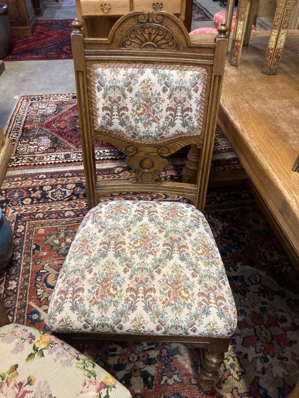 A set of four late Victorian carved oak dining chairs and a pair of Edwardian carved mahogany bedroom chairs (6)